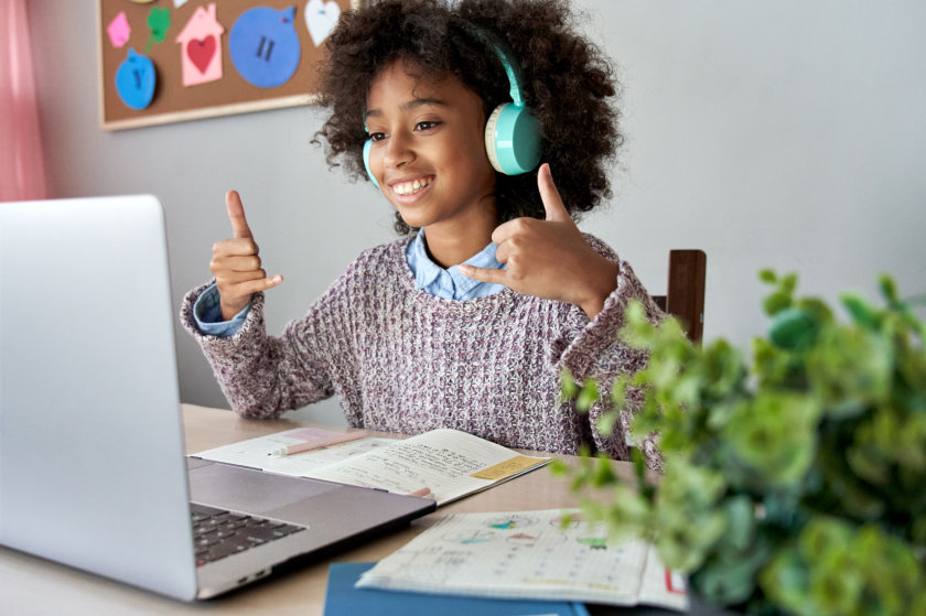 a girl wearing headphones while doing thumbs up