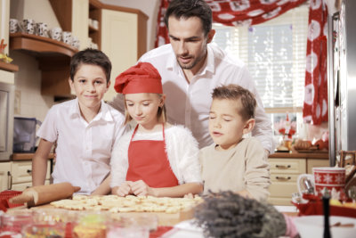 a person and kids in a kitchen